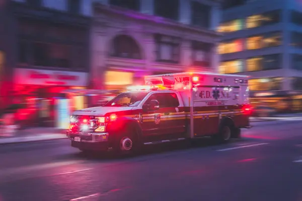 New York, US - May 8, 2023 - Emergency Pick-up Truck Passing Fast at Night in Manhattan, New York.
