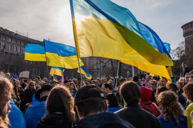 MILAN, ITALY - FEBRUARY 25, 2023: One year after Russia-Ukraine war, 1st anniversary. Rally of the population in support of Ukraine in Milan, Castello Sforzesco. clipart