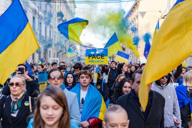 MILAN, ITALY - FEBRUARY 25, 2023: One year after Russia-Ukraine war, 1st anniversary. Rally of the population in support of Ukraine in Milan street. clipart