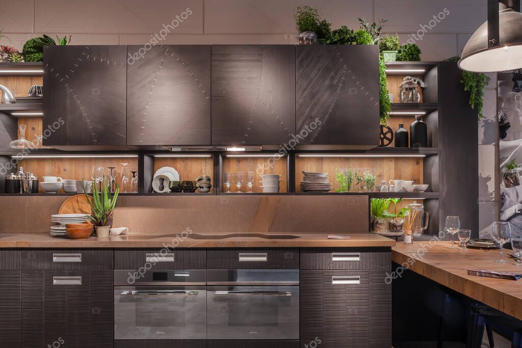 MILAN, ITALY - APRIL 22, 2018: 57th exhibition of Salone Internationale del Mobile during Milan design week. Numerous visitors to the Fiera Rho Milano. Interior of an exhibition stand of a kitchen company.