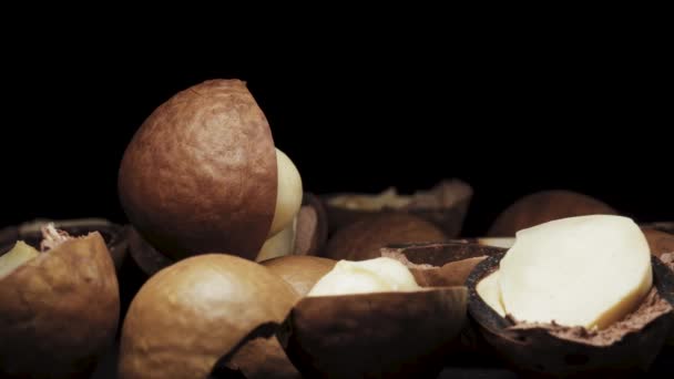 Piulița Macadamia Din Coajă Rotește Fundal Negru Coajă Nuci — Videoclip de stoc