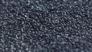 Makro kaydırak, soyutlama, küçük siyah taşlar.
