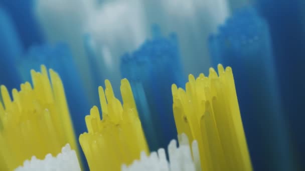 Macro Slide Shot Toothbrush White Yellow Blue Threads — Vídeos de Stock