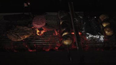 Grilled dinner. Mushrooms and potatoes. Place the burger cutlet on the wire rack.
