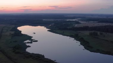 Drone video. In summer. Sunset, Fog night with a red sky, over a lake in the forest