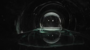 Macro video of a glass bottle. Dolly slider inside a water bottle close-up. Laowa Probe