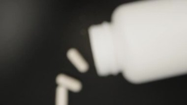 Inside a jar of pills, I throw pills. Dolly slider extreme close-up inside. Laowa Probe