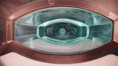 Camera inside a bottle of blue rinse aid. Dolly slider extreme close-up inside. Laowa Probe