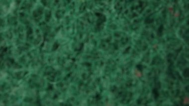 I drip detergent on a green sponge, top view. Dolly slider extreme close-up inside. Laowa Probe