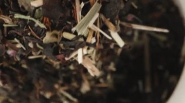 I take out a spoon from a jar of tea, top view. Dolly slider extreme close-up inside. Laowa Probe