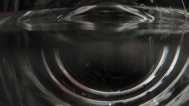 I pour out the water from the measuring cup. Dolly slider extreme close-up inside. Laowa Probe