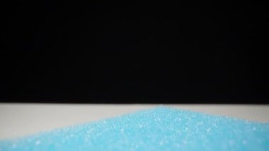 I drip green gel onto a blue dishwashing sponge. Dolly slider extreme close-up. Laowa Probe