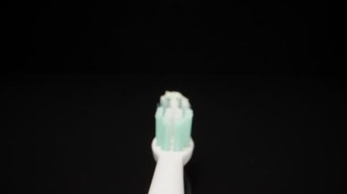 Squeezing toothpaste on a toothbrush. Dolly slider extreme close-up. Laowa Probe