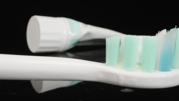 Electric Toothbrush Lies Black Table Vibrates Dolly Slider Extreme Close — Vídeo de Stock