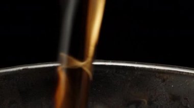 I pour cola into a glass with ice, bubbles and splashes. Dolly slider extreme close-up. Laowa Probe