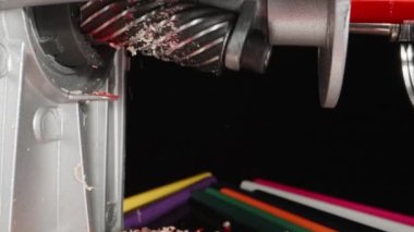 I sharpen a red pencil, shavings fly. Dolly slider extreme close-up. Laowa Probe