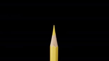 Yellow pencil on a black background, magnification. Dolly slider extreme close-up. Laowa Probe