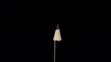 Black pencil on a black background, magnification. Dolly slider extreme close-up. Laowa Probe