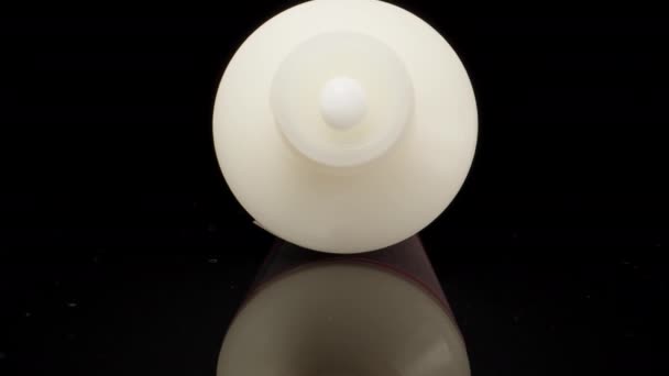 Squeezing White Cream White Tube Black Table Dolly Slider Extreme — стоковое видео