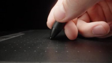 I write on a black graphics tablet. Dolly slider extreme close-up. Laowa Probe
