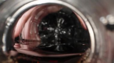 I pour soda into a glass with ice, bubbles and splashes. Dolly slider extreme close-up inside. Laowa Probe