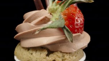 cupcake with a heart-shaped candle, and strawberries with chocolate, rotates. Dolly slider extreme close-up. Laowa Probe