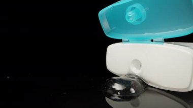 Antiseptic gel leaked out of the jar onto the table. Dolly slider extreme close-up. Laowa Probe