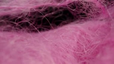 pink woolen fabric, thread. Dolly slider extreme close-up inside. Laowa Probe