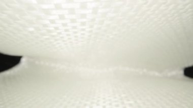 Camera flight inside, under sheets of white fiberglass. Dolly slider extreme close-up. Laowa Probe