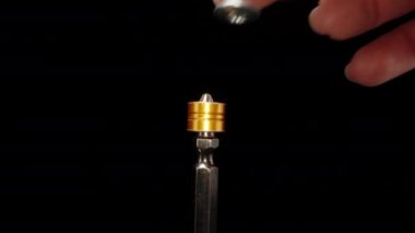 Magnetic screwdriver, put a screw, rotation. Dolly slider extreme close-up. Laowa Probe