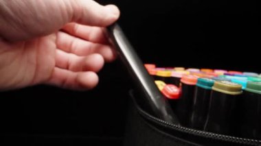 I take out a pink marker from a bag of colored markers. Dolly slider extreme close-up. Laowa Probe