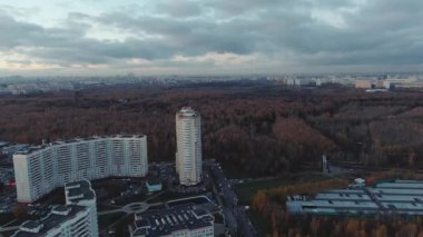 Autumn in the city, drone video. Red trees in cloudy weather. urban landscape