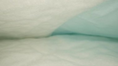 Blue absorbent diapers for babies. Dolly slider extreme close-up, inside. Laowa Probe
