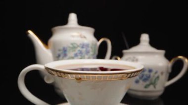 Tea party, I throw a piece of sugar into a cup of tea, splashes. Slow motion, Dolly slider extreme close-up. Laowa Probe