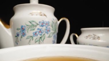 Tea drinking, I pour sugar from a spoon into a cup. Slow motion, Dolly slider extreme close-up. Laowa Probe