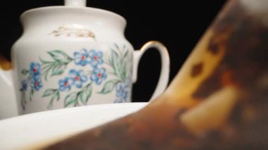 Tea drinking, I dip a tea bag, a pyramid into a cup. Slow motion, Dolly slider extreme close-up. Laowa Probe