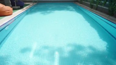 Lonely and deserted blue pool on a sunny day.