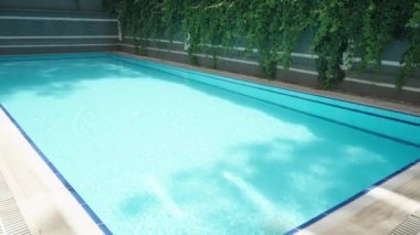 Lonely and deserted blue pool on a sunny day.