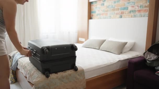 Young Woman Packs Her Things Bed Suitcase Unzips — Vídeo de stock