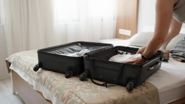Young Woman Packs Her Things Bed Suitcase Sunny Day — Vídeo de stock