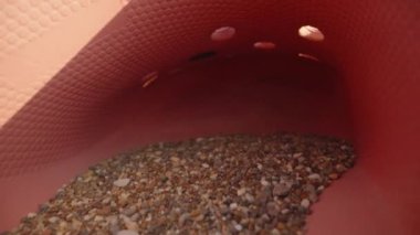 Sand lies in a rubber slipper. The sea is in the background. Dolly slider extreme close-up. Laowa Probe