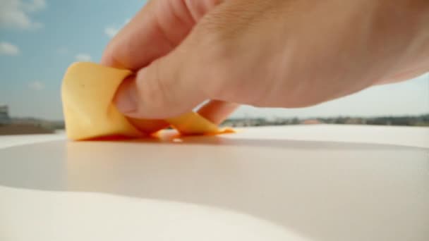 Man Wipes White Table Orange Rag Blue Sky Dolly Slider — Stock Video