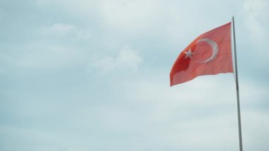 Large flag of Turkey in Antalya on a rock, against the sky