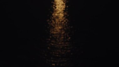 Strawberry supermoon over the sea. Reflection on the water. The boat sails in the light of the moon