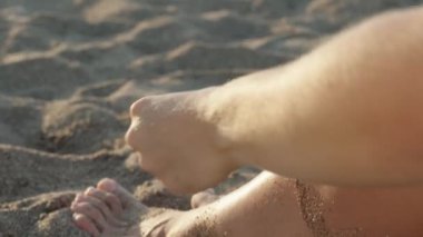 Plajdaki genç bir kadın plastik bir kutudan kirazları çıkarıp yemek yiyor. Yakın çekim, yavaş çekim