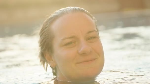 Young Woman Pool Smiles Camera Says Something Turns Away Face — Stock Video