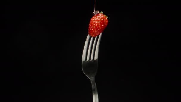 Strawberry Impaled Fork Rotates Black Background Chocolate Drops — Stock Video