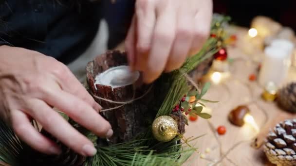 Young Woman Makes Christmas Decorations Ties Bow Bark Tree Candle — Stock Video