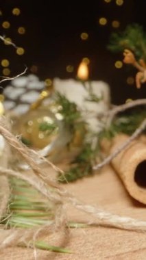 Dikey video. Süslü Noel masası, Noel Baba 'nın şapkasının üzerinde fenerlerin arasından süzülen kamera. Dolly sürgülü aşırı yakın çekim içeride. Sonda