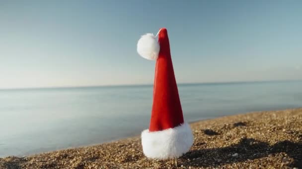 Circling Red Santa Hat Hanging Stick Seaside Sunny Morning — Stock Video